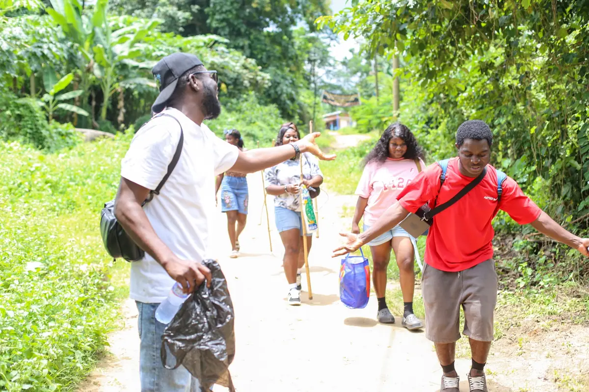 VibeTrails group walking along a green path on the Upper Wli Falls trip